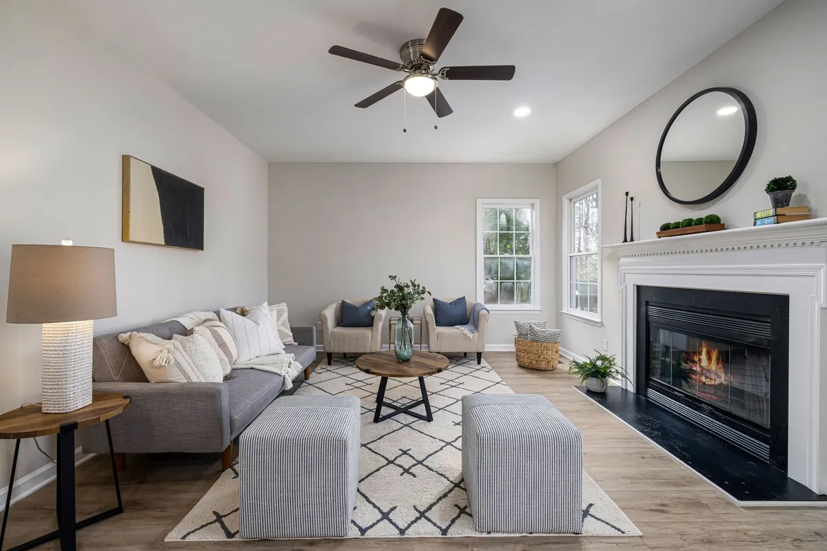 A cozy living room with a fireplace and modern furniture, ideal for attracting buyers in a quick home sale.